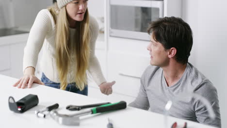 Couple,-fight-and-stress-with-plumbing-in-kitchen