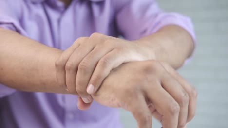 person checking wrist pain