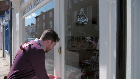 shop owner opening up record, cd and hi-fi shop