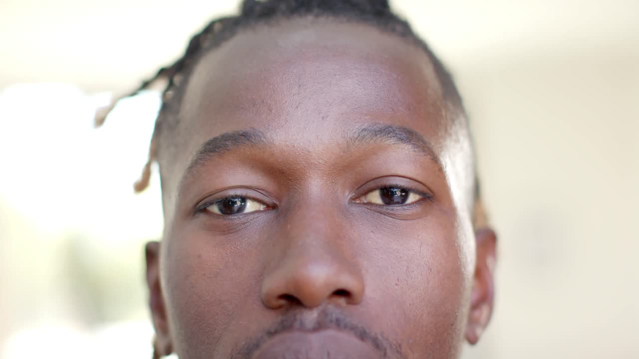 Portrait close up of happy african american man short dreadlocks smiling, in slow motion