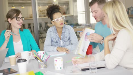 man sharing documents with coworkers