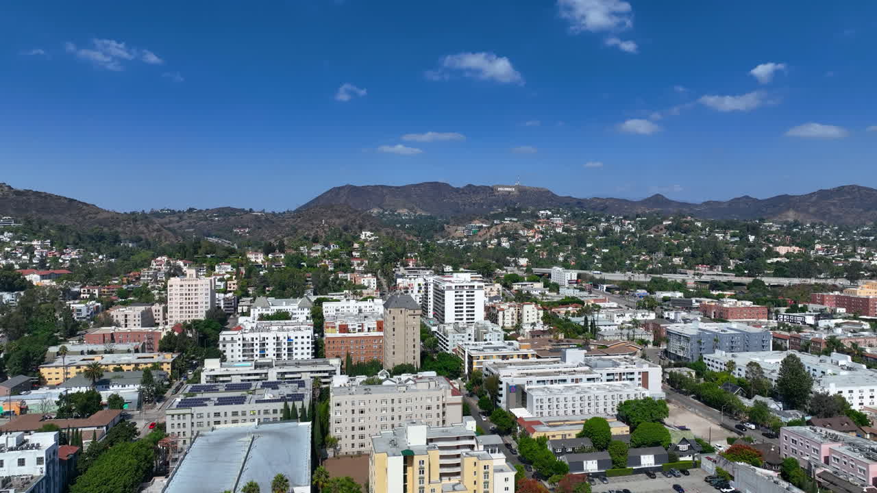 Aerial tracking shot overlooking the Hollywood cityscape of Los Angeles, USA