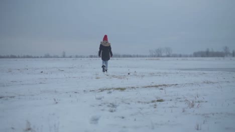 a young woman walks into the distance