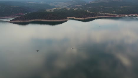 calm waters of the lake with boats and reflections at flaming gorge reservoir, wyoming, usa - aerial drone shot
