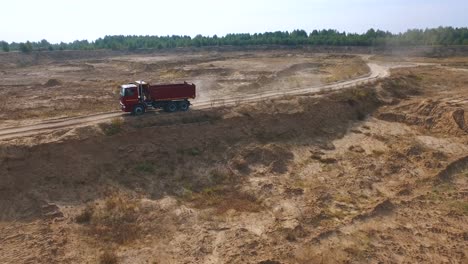 red dump truck in a sand quarry