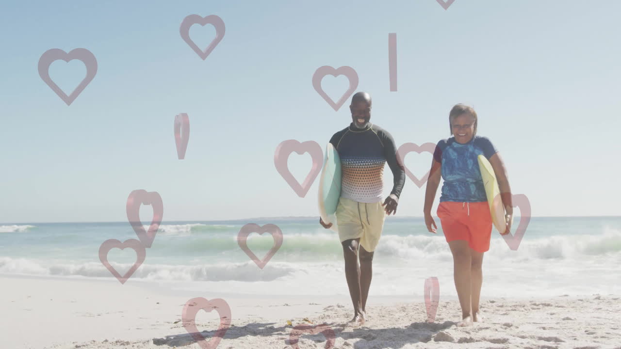 Father and son walking on beach with heart shapes overlay animation