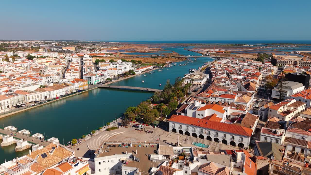 Aerial shot over the historic town of Tavira showing the roman bridge over the Gilao river and the atlantic ocean in the background, Algarve region, Portugal