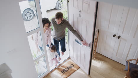 Elevated-View-Of-Family-Returning-Home-After-Trip-Out-With-Excited-Children-Running-Ahead