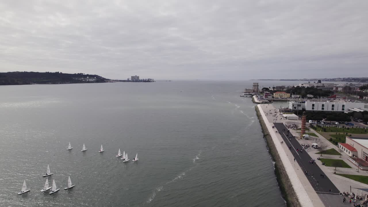 Aerial flyover Lisbon's Tagus River Unveils Belém Tower on Its Serene Banks