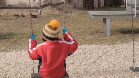 little boys singing on a swing in a park stock video