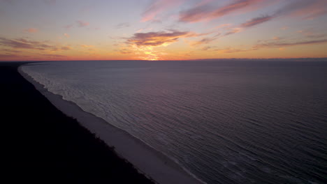colorful sunset on horizon at baltic sea, krynica morska beach, aerial