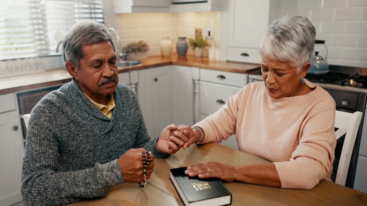 Senior couple, faith and praying with bible