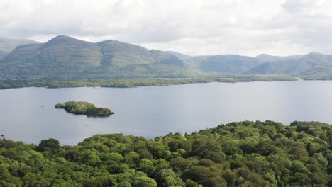 aerial - mountains in killarney national park and muckross lake, ireland, truck left