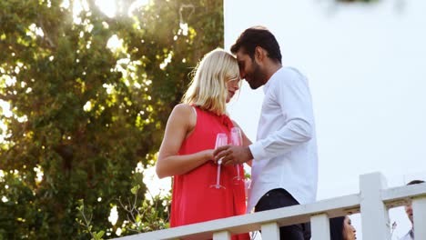 affectionate couple having champagne in balcony