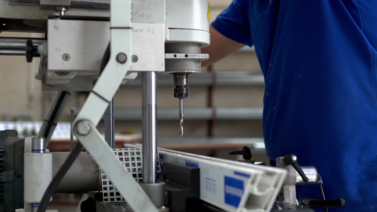 Factory Workers Operating PVC Frame Manufacturing Equipment