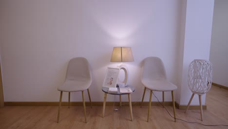 empty waiting room with chairs and lamp