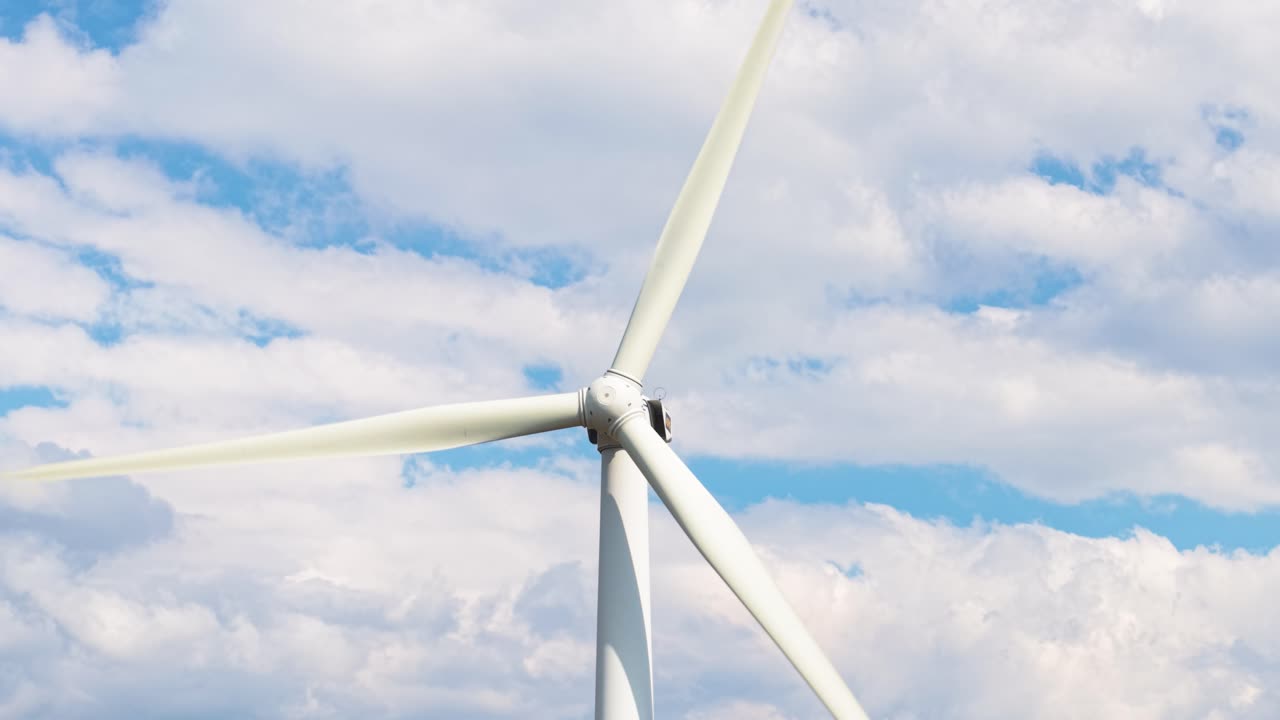 High-detail shot of spinning blades with vibrant blue sky. Filmed near Buzludzha, symbolizing sustainable and green energy technology