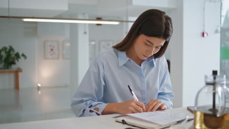 company employee signing contract in office closeup. business partners agreement