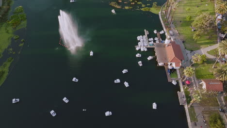 Aerial-Drone-Shot-of-Swan-Boats-in-Echo-Park-Lake-by-Fountain,-Sunny-Los-Angeles-Day-at-the-Park