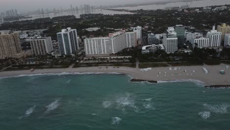 miami beach at sunrise, buildings, sea and white sand