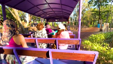 tourists enjoy scenic tram ride in thailand