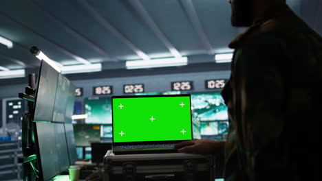 Army-specialist-operating-surveillance-tech-with-chroma-key-laptop