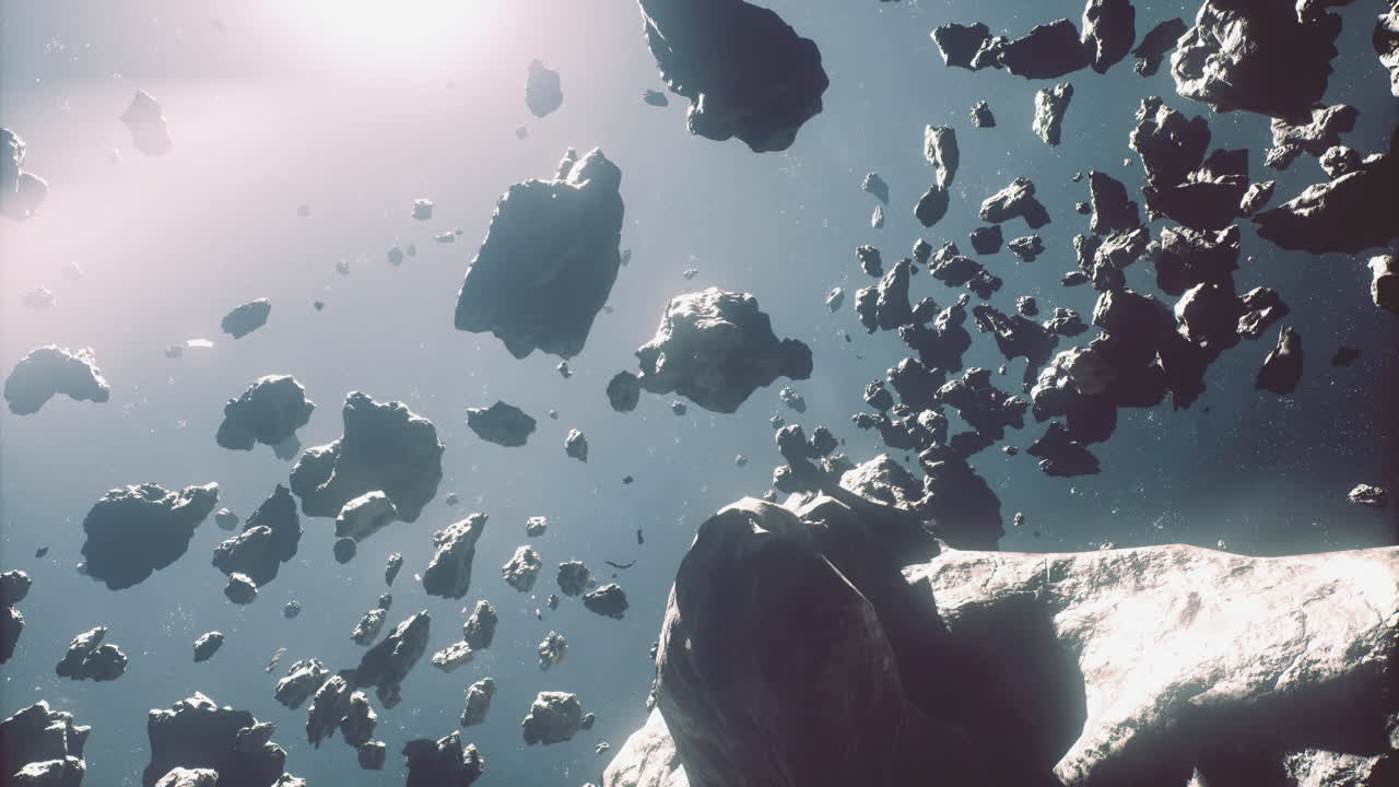 Asteroid field illuminated by distant sunlight in outer space