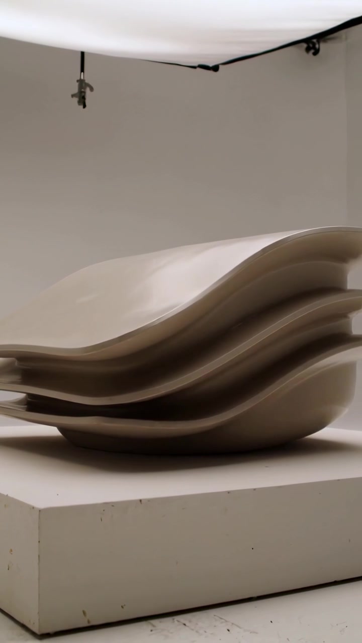 Vertical video: Panning cam showing stacked sculpture on plinth in studio for catalog softbox clamp