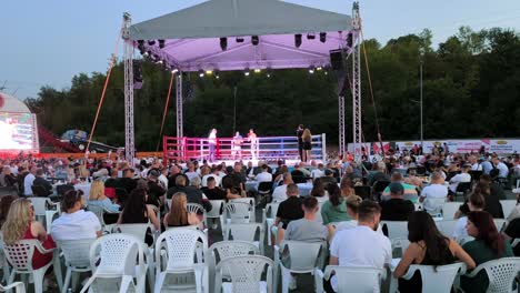 slow-motion clip of a boxing match, with intense punches and movements in a boxing ring as people watch