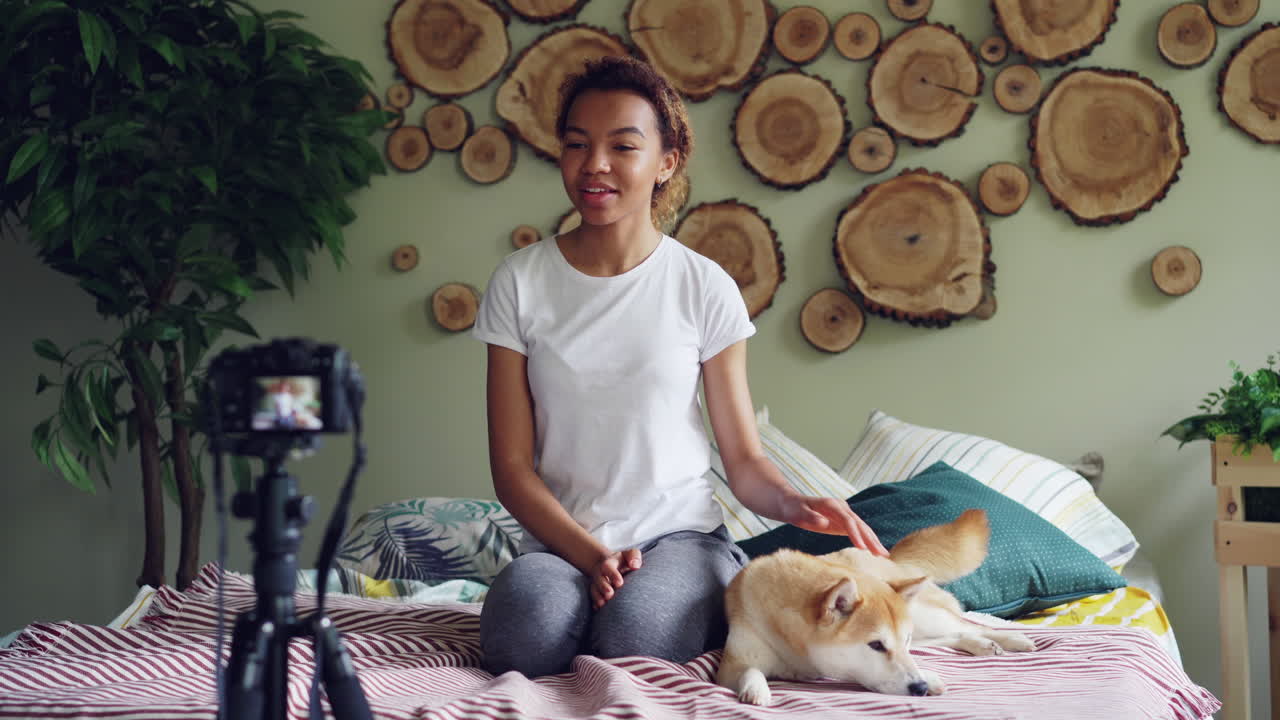 Teenage Girl Vlogging with her Dog in a Bedroom