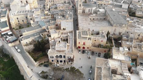 mdina city walls and old cityscape, near the cathedral of saint paul - aerial fly-over slow tilt up shot