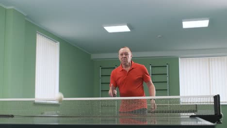 a man in a wheelchair plays ping pong. people with disabilities play table tennis. rehabilitation of the disabled. sport.