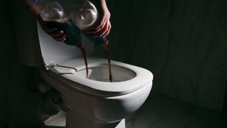 pouring out cola into the toilet