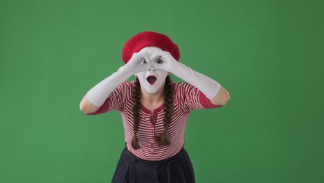 astonished mime artist looking at something interesting with handmade binoculars