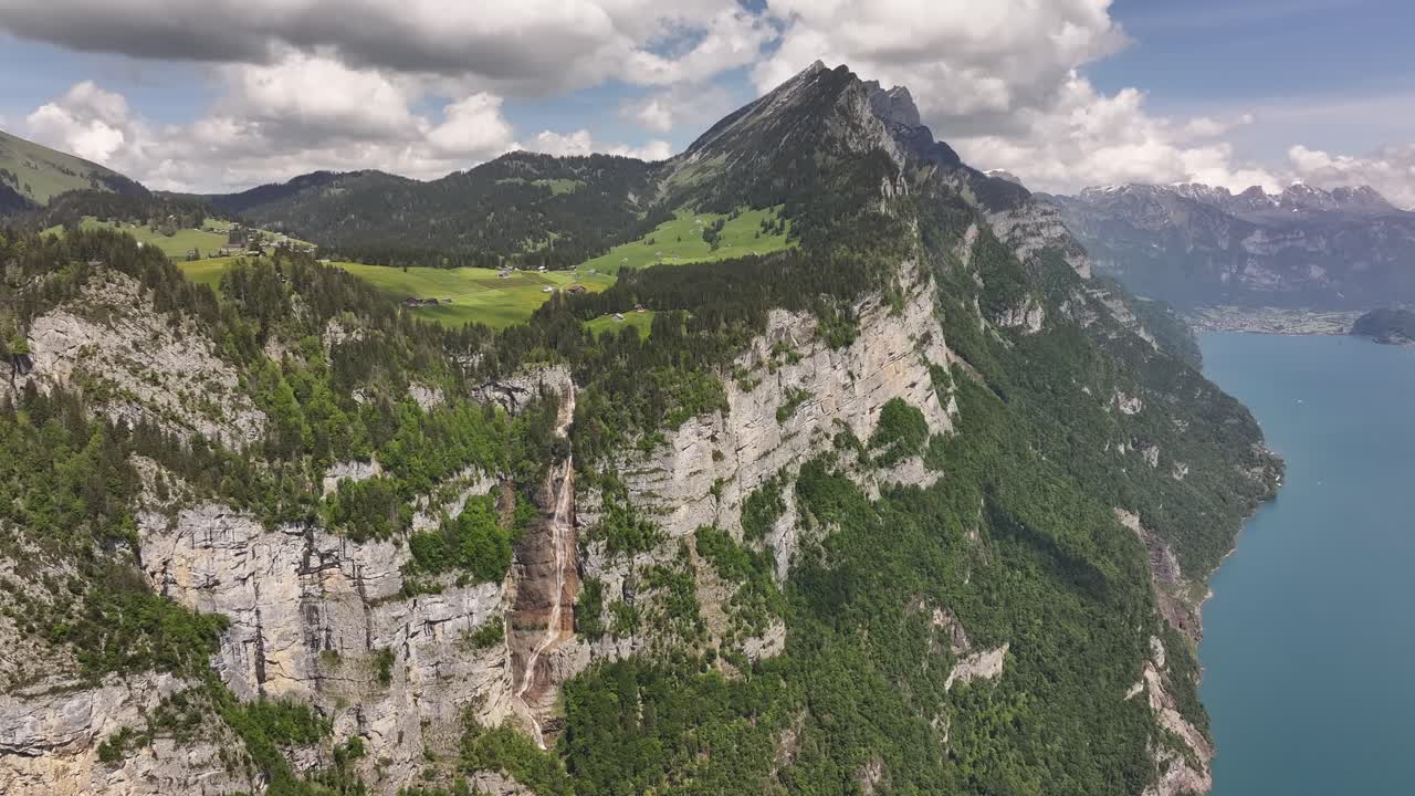 towering cliffs with seerenbachfälle waterfall and lake walensee below