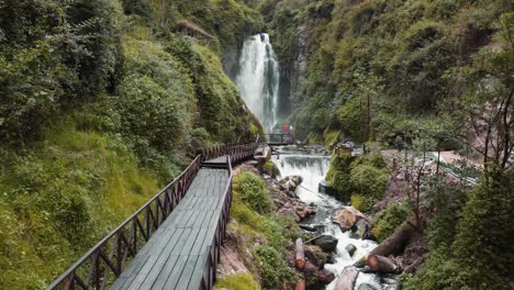 aerial view along empty wooden bridge leading to peguche waterfalls in otavalo