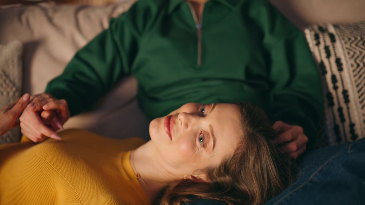 Gentle girlfriends relaxing evening apartment enjoying bonding moment closeup.