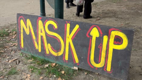 sign encourages the wearing of masks because of covid