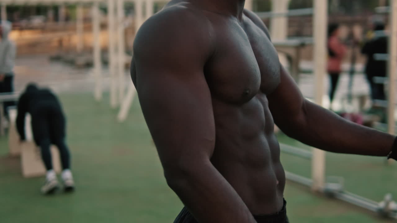 Uomo muscoloso che fascia le mani prima dell'allenamento all'aperto