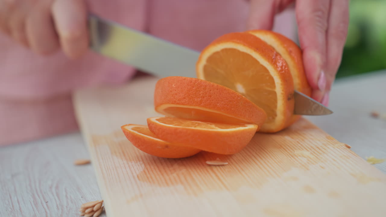 Caucasian Hands Prepare Fresh Juice, Morning Sunlight Illuminates Freshly Sliced Citrus On Cutting Board, Bright Sunlight Highlights Vivid Orange Slices Being Prepared On Wooden Tabletop In Kitchen