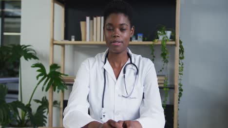 portrait of african american female doctor having a video chat talking and smiling