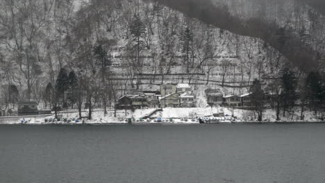 snow covered empty vacation homes along the shore of lake chuzenji, nikko, tochigi, japan.