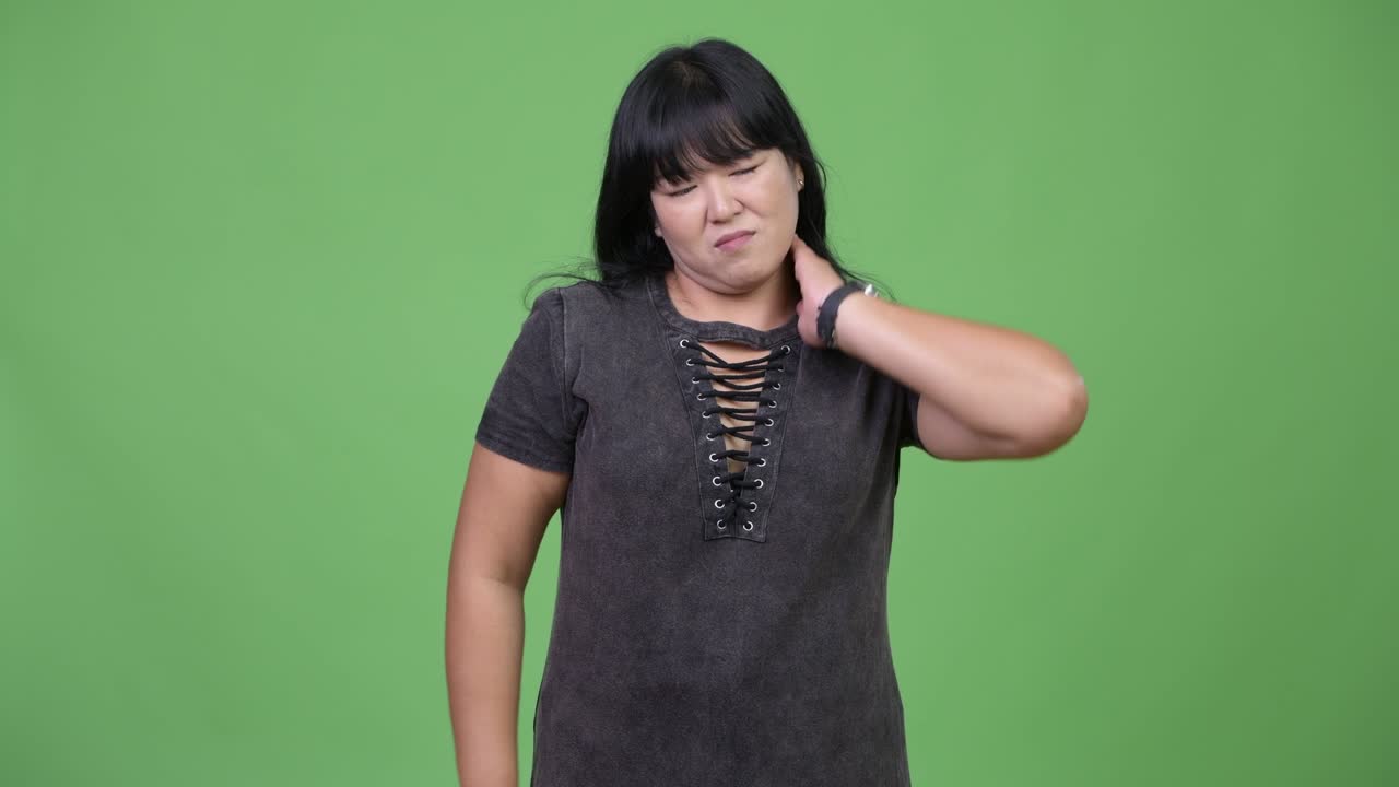 Beautiful overweight Asian woman having neck pain