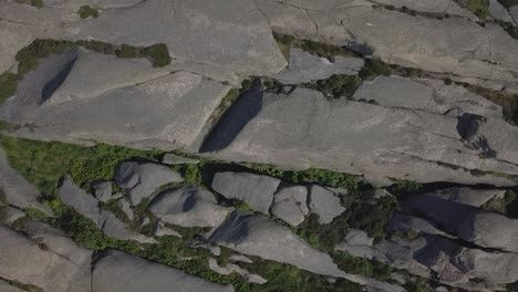 drone ascend, zooms up into the sky with rocky coastal terrain