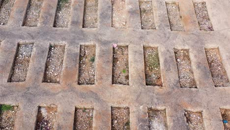 concrete surface with rectangular gravel-filled openings