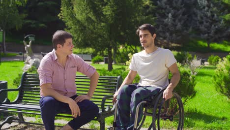 the physically disabled young man is chatting with his friend.