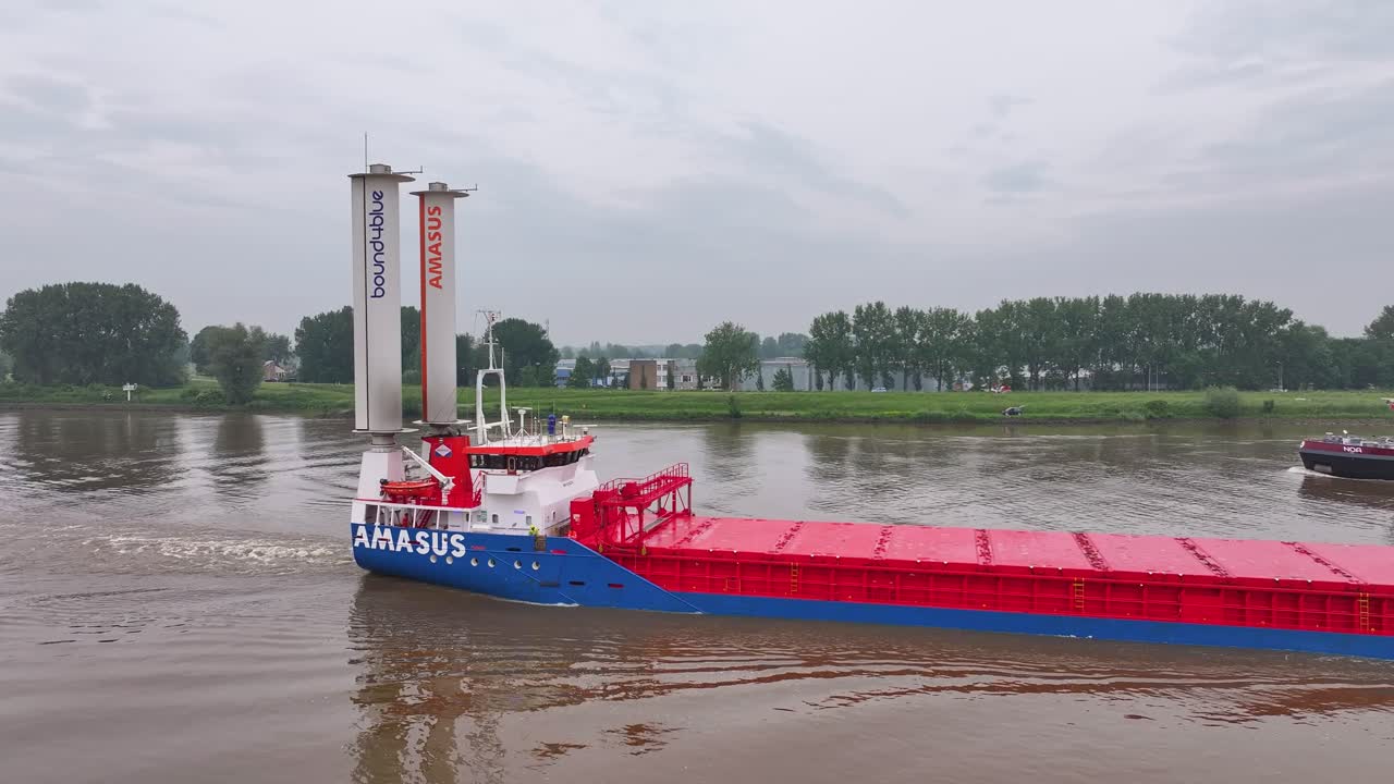 EEMS Traveller Cargo Ship with Rotor Sails on a River