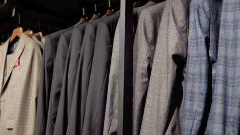 showcase with jackets from the new collection in the luxury boutique of men's suits. men's clothing store