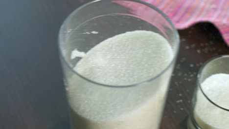 sugar in container. sugar in glass and plastic containers. closeup