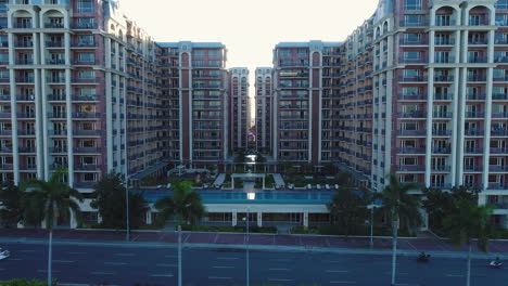 Dolly-In-Aerial-Shot-Of-A-Luxury-Condominium-With-Swimming-Pool-In-Manila-During-Morning